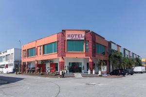 a hotel building on a street with a parking lot at Night Queen Express Hotel KLIA T1 and KLIA T2 in Sepang