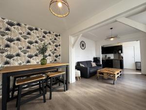 a living room with a table and a couch at L'Arrivée - Circuit - 6 pers - Rêve au Mans in Le Mans +14 photos