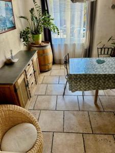 a room with a table and chairs and a table and a window at Charming Village House in the Heart of Isle-sur-la-Sorgue in LʼIsle-sur-la-Sorgue