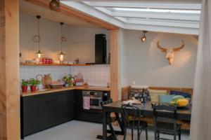 a kitchen with a table and a table and chairs at Logement de Appelgaard in Culemborg
