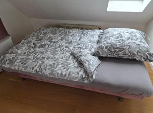 a bed with two pillows on top of it at Studio Apartment for 1-2 People with Rhine View in Rüdesheim am Rhein