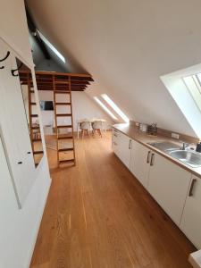 an attic kitchen with a ladder and a sink at Studio Apartment for 1-2 People with Rhine View in Rüdesheim am Rhein