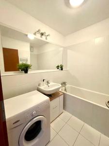 a bathroom with a washing machine and a sink at Three towers with parking in Bratislava