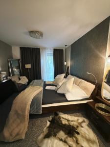 a large bedroom with a large bed and a window at Koliba 22 in Bratislava