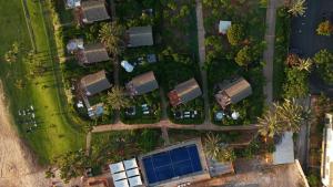 an overhead view of a yard with houses and a large building at Laguava Resort in Ar Rumaylah