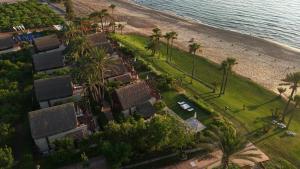 an aerial view of a resort with palm trees and the beach at Laguava Resort in Ar Rumaylah