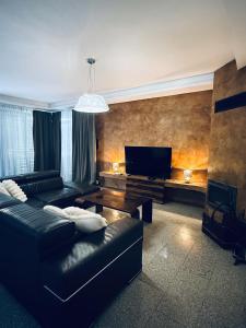 a living room with a couch and a tv at Koliba 22 in Bratislava