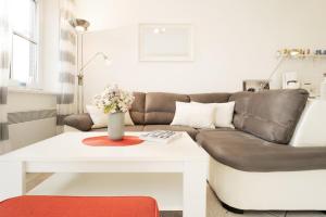 a living room with a couch and a table at Happy Place in Bojendorf