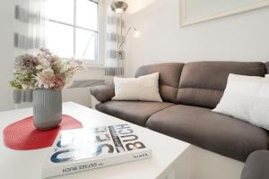 a living room with a couch and a book on a table at Happy Place in Bojendorf