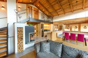 a living room with a couch and a fireplace at Gams Lodge in Enkerbichl +16 photos
