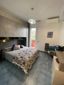 a bedroom with a large bed and a large window at Villa Caribe affittacamere in Monterosso al Mare