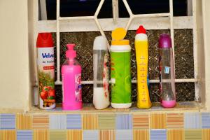 Ein Stapel Flaschen steht aufgereiht in einem Regal. in der Unterkunft Studio bnb by Tsparks in Gatunga