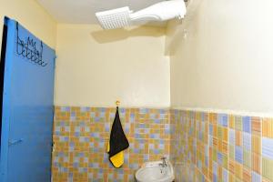 ein Badezimmer mit Waschbecken und Toilette in einem Zimmer in der Unterkunft Studio bnb by Tsparks in Gatunga