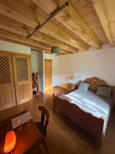 a bedroom with a large bed and a table at Séjour paisible près de Genève in Neydens