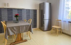 a dining room with a table and a refrigerator at Gorgeous Apartment In Högsby With Wifi in Högsby