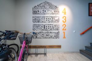 a pink bike is parked next to a wall at Loft - HI Eco Hostel in Reykjavík