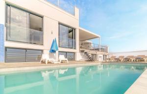 a house with a swimming pool next to a house at Cozy Home In Torrox Costa in Torrox Costa