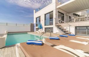 a villa with a swimming pool and a house at Cozy Home In Torrox Costa in Torrox Costa