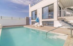 a swimming pool in front of a house at Cozy Home In Torrox Costa in Torrox Costa +21 photos