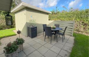 a patio with a table and chairs in a backyard at 3 Bedroom Pet Friendly Home In Hemmet in Falen +12 photos