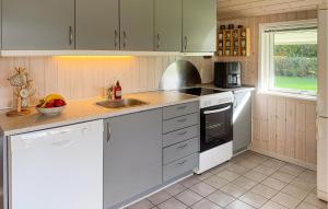 a kitchen with white cabinets and a sink at 3 Bedroom Pet Friendly Home In Hemmet in Falen