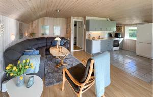 a living room and kitchen with a couch and a table at 3 Bedroom Pet Friendly Home In Hemmet in Falen