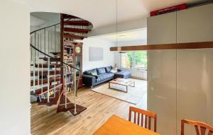 - un salon avec un canapé bleu et un escalier en colimaçon dans l'établissement Stunning Home In Friedrichskoog With Wifi, à Friedrichskoog-Spitz