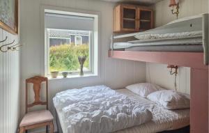 a bedroom with two bunk beds and a window at 3 Bedroom Beautiful Home In Hurup Thy in Doverodde +8 photos
