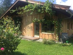 een houten hut met een veranda en een deur bij Achberghütte in Unken