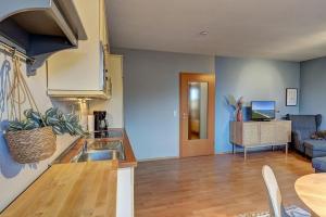 a kitchen and living room with a couch and a table at Fewo Melli in Zempin