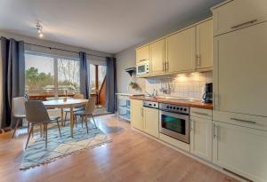 a kitchen with a table and a dining room at Fewo Melli in Zempin +5 photos