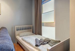 a small bedroom with a bed with shoes on it at Fewo Melli in Zempin