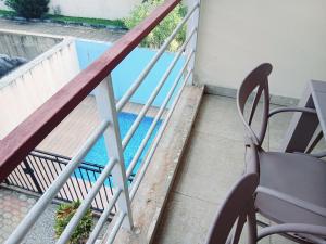 a balcony with a view of a swimming pool at Résidence Meublée Yaya Azur in Azuretti +6 photos