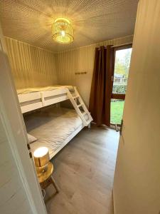 a room with two bunk beds and a window at Gîte au calme en pleine nature in Signy-le-Petit