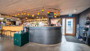 a bar in a restaurant with a counter and chairs at Loft - HI Eco Hostel in Reykjavík +120 photos