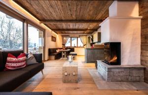 a living room with a couch and a fireplace at Chalet Hauserberg in Gumpenberg