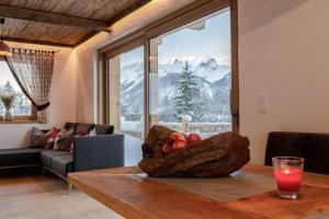 a room with a table with a bowl of fruit on it at Chalet Hauserberg in Gumpenberg +16 photos