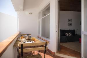 a room with a table with a tea kettle on it at Calheta House in Luz in Luz