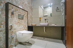a bathroom with a toilet and a sink at Shreeji Desert Resort in Sām