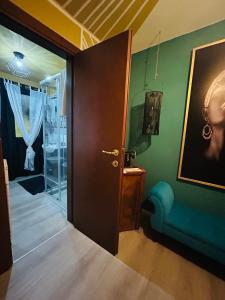 a room with a door and a couch and a painting at Family House di Genny e Nicola small suite in Chioggia