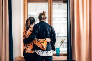 a woman looking out of a window at Hotel Finn in Helsinki