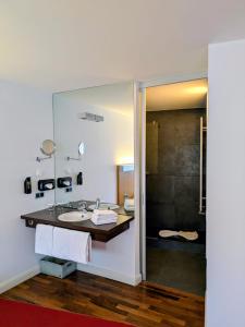 a bathroom with a sink and a shower at Nena Hotel Bremen in Bremen