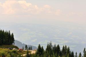 a view of a mountain with cars parked on a hill at Almliebe-Feriendorf Koralpe in Elsenbrunn +11 photos