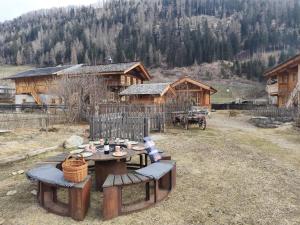 a picnic table and chairs in front of a cabin at Kuschelchalet in Großkirchheim