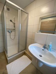 a bathroom with a shower and a sink at Haven Hannover in Hannover