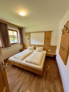 a bedroom with two beds and a large window at Chalet Amade in Forstau
