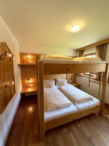 two bunk beds in a room with wooden floors at Chalet Amade in Forstau +6 photos