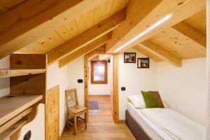 a small room with a couch in a tiny house at Chalet Lamada in Livigno