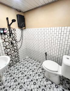 a bathroom with a toilet and a sink at af house villa and cabin in Kejajar