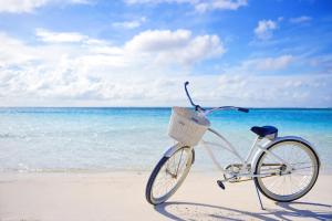 a bike with a basket parked on the beach at Hotel Indigo Turks & Caicos Grace Bay by IHG in The Bight Settlements
